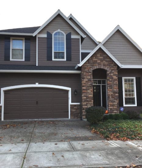 Chocolate brown house with white trim and black door