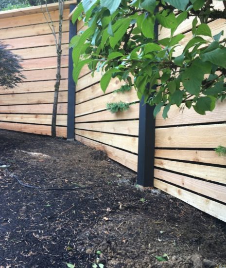 Cedar fence with fan detail to follow the slope