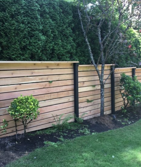 cedar fence with horizontal boards and black posts